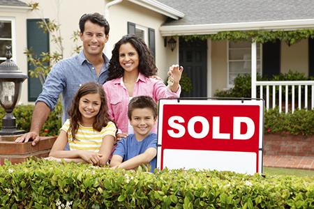 Family in front of sold home